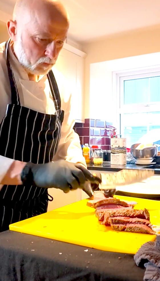 Private chef Giuseppe Manzoli hand-carving a sous vide beef fillet at Loch Tay, Scotland.