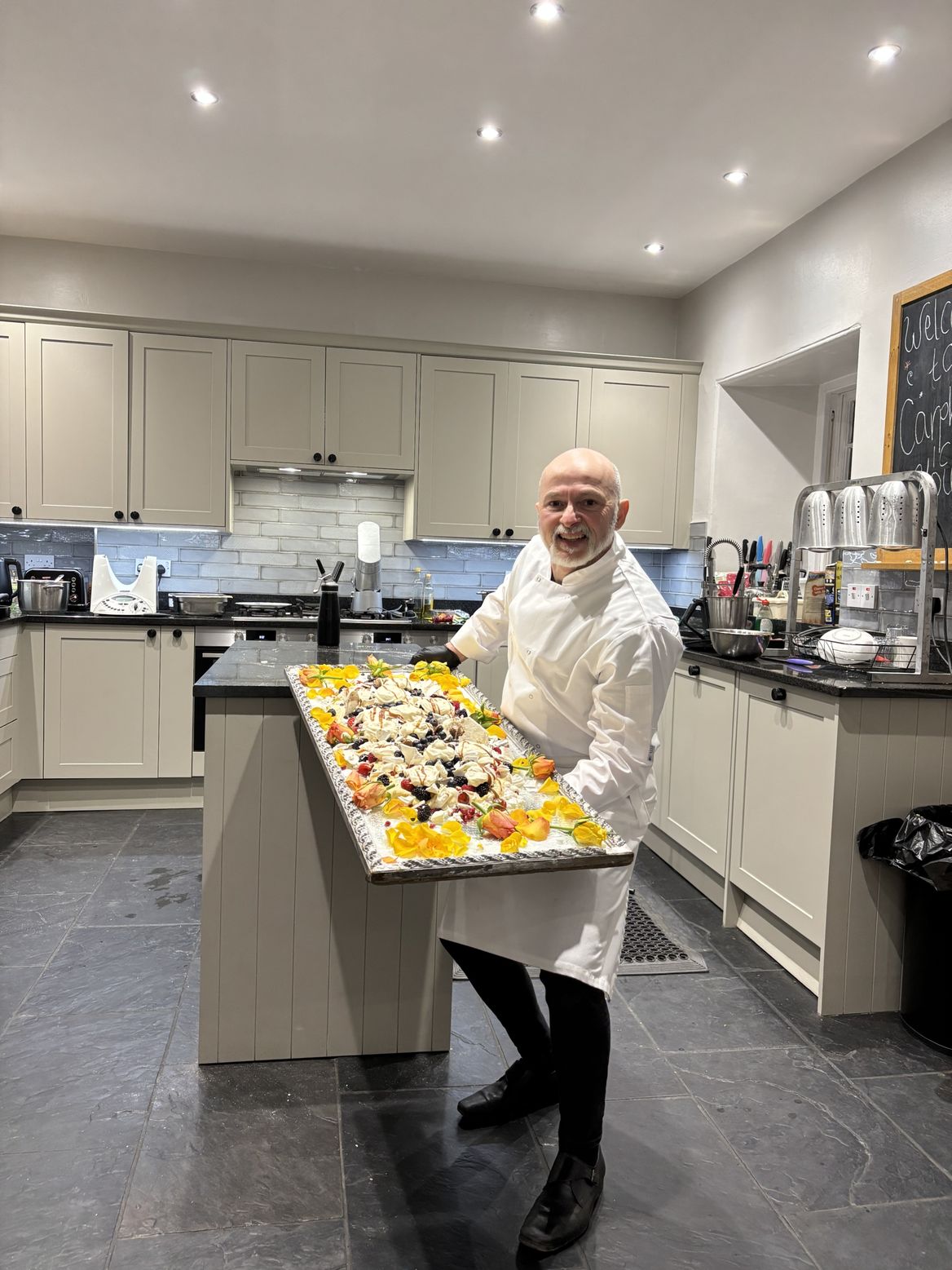 Italian private chef Giuseppe Manzoli with handmade Pavlova dessert at Carphin House Fife Scotland