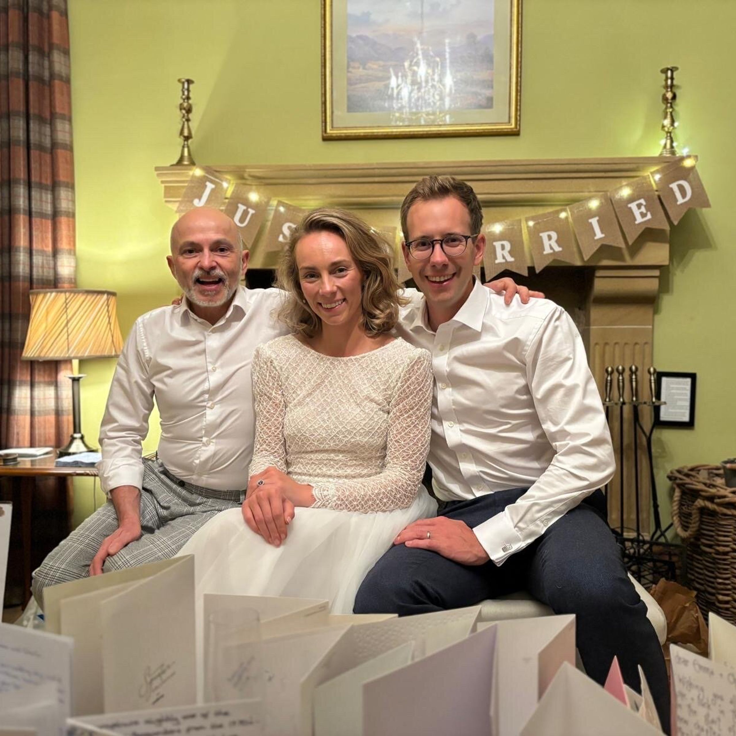 Bride and groom with private chef Giuseppe Manzoli under the Just Married banner at Easter Kincaple Farmhouse