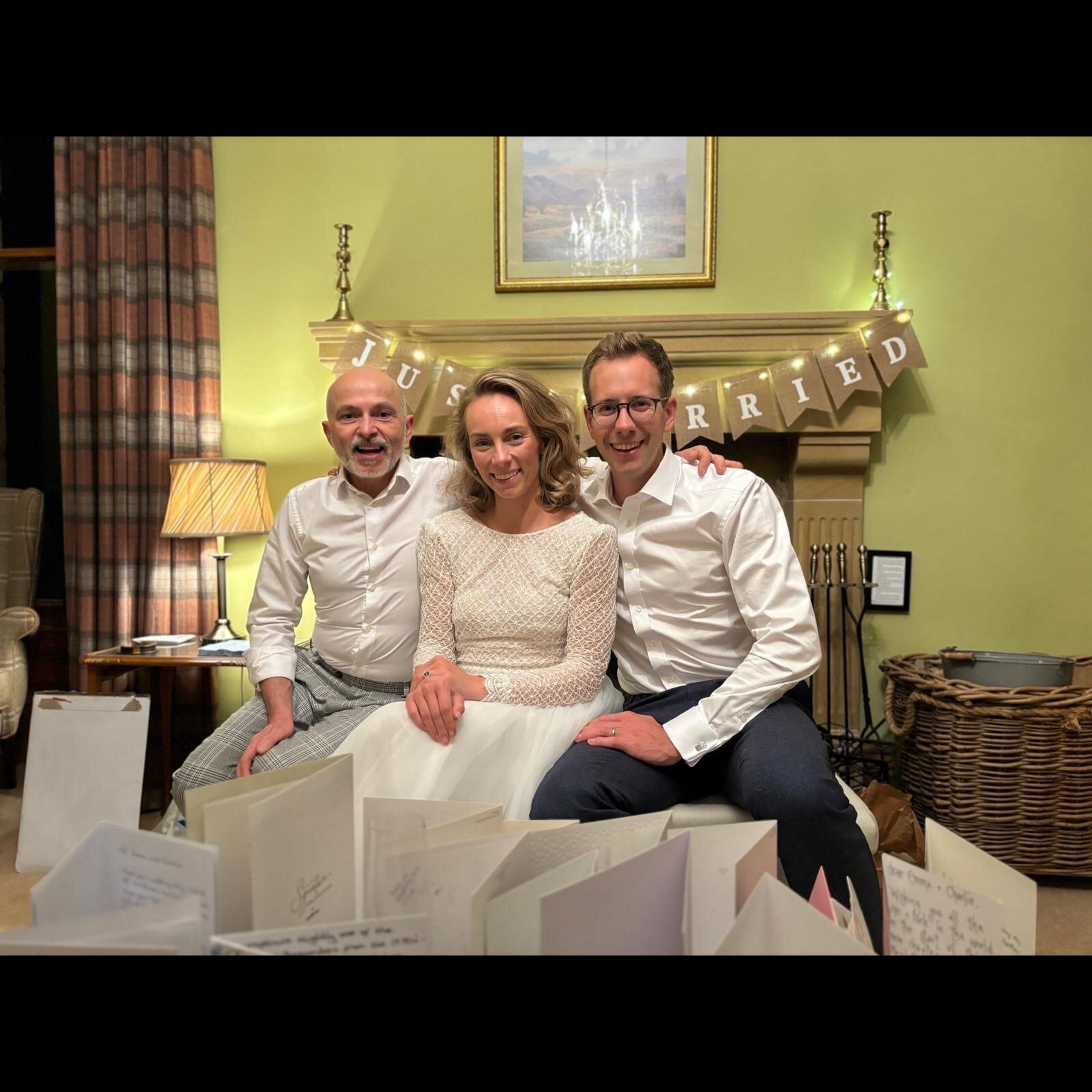 Bride and groom with private chef Giuseppe Manzoli under the Just Married banner at Easter Kincaple Farmhouse
