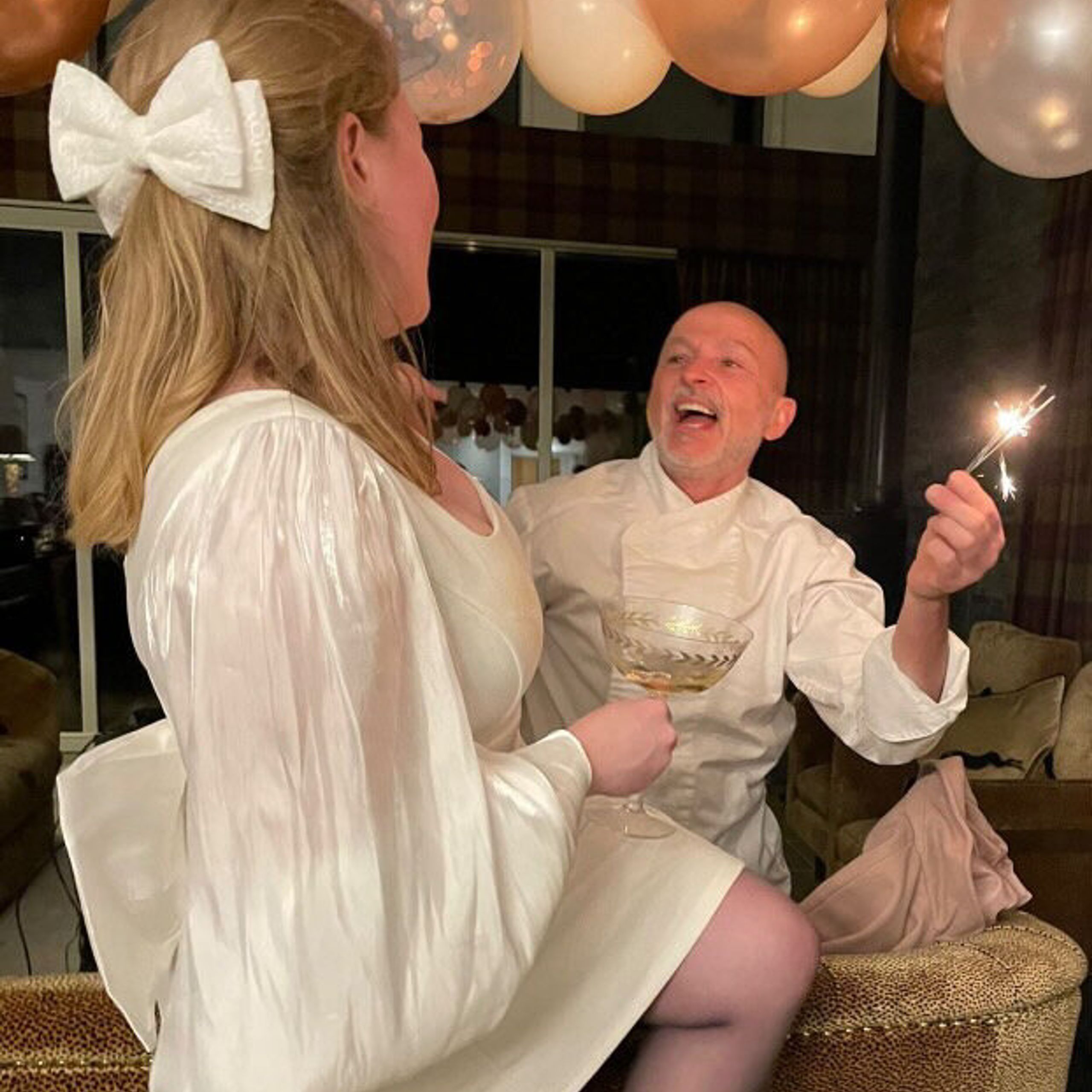 Bride-to-be and private chef Giuseppe Manzoli with sparklers under the balloons at a hen party at Kipney Lodge