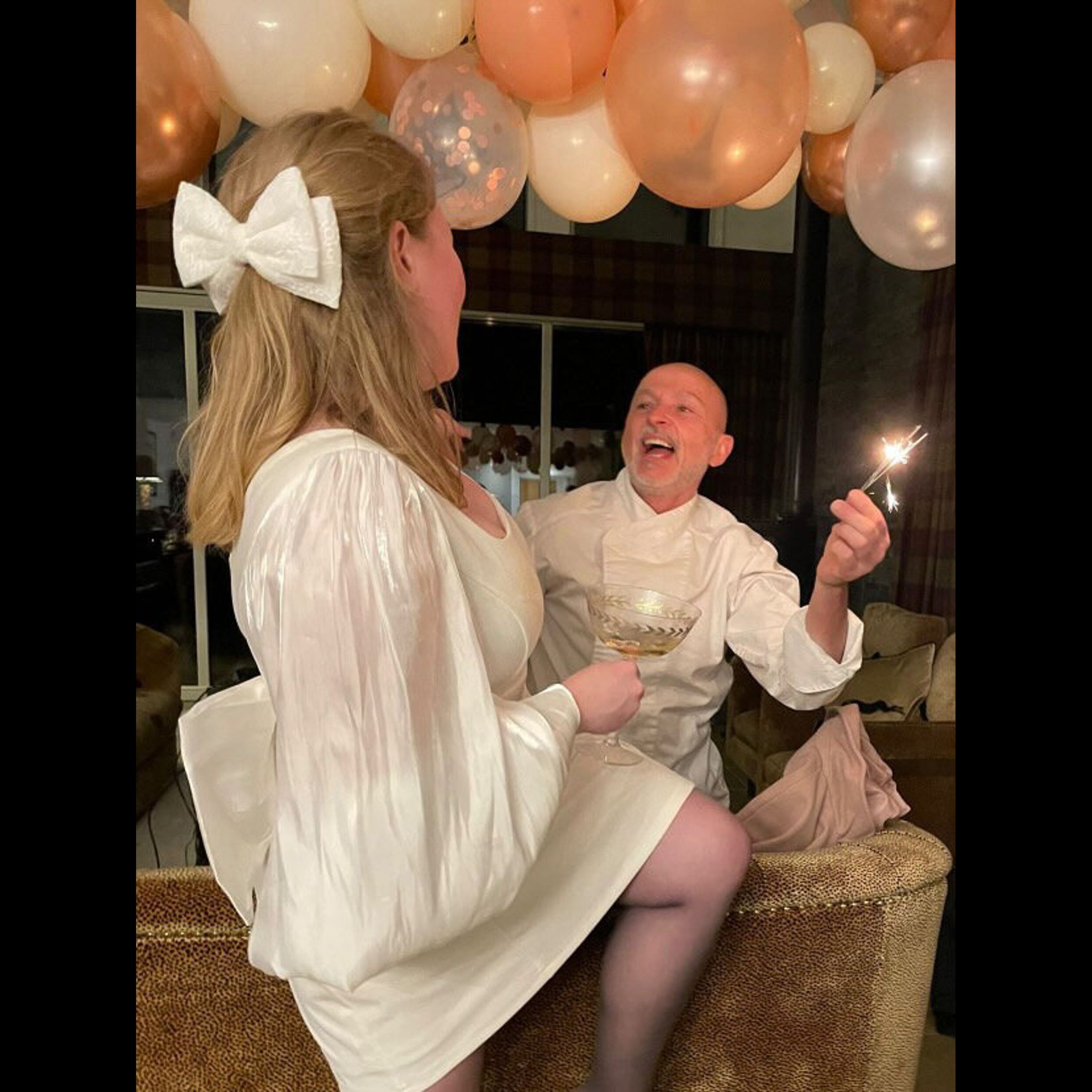 Bride-to-be and private chef Giuseppe Manzoli with sparklers under the balloons at a hen party at Kipney Lodge