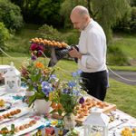 Italian private chef Giuseppe Manzoli plating a buffet at a private garden event in Scotland