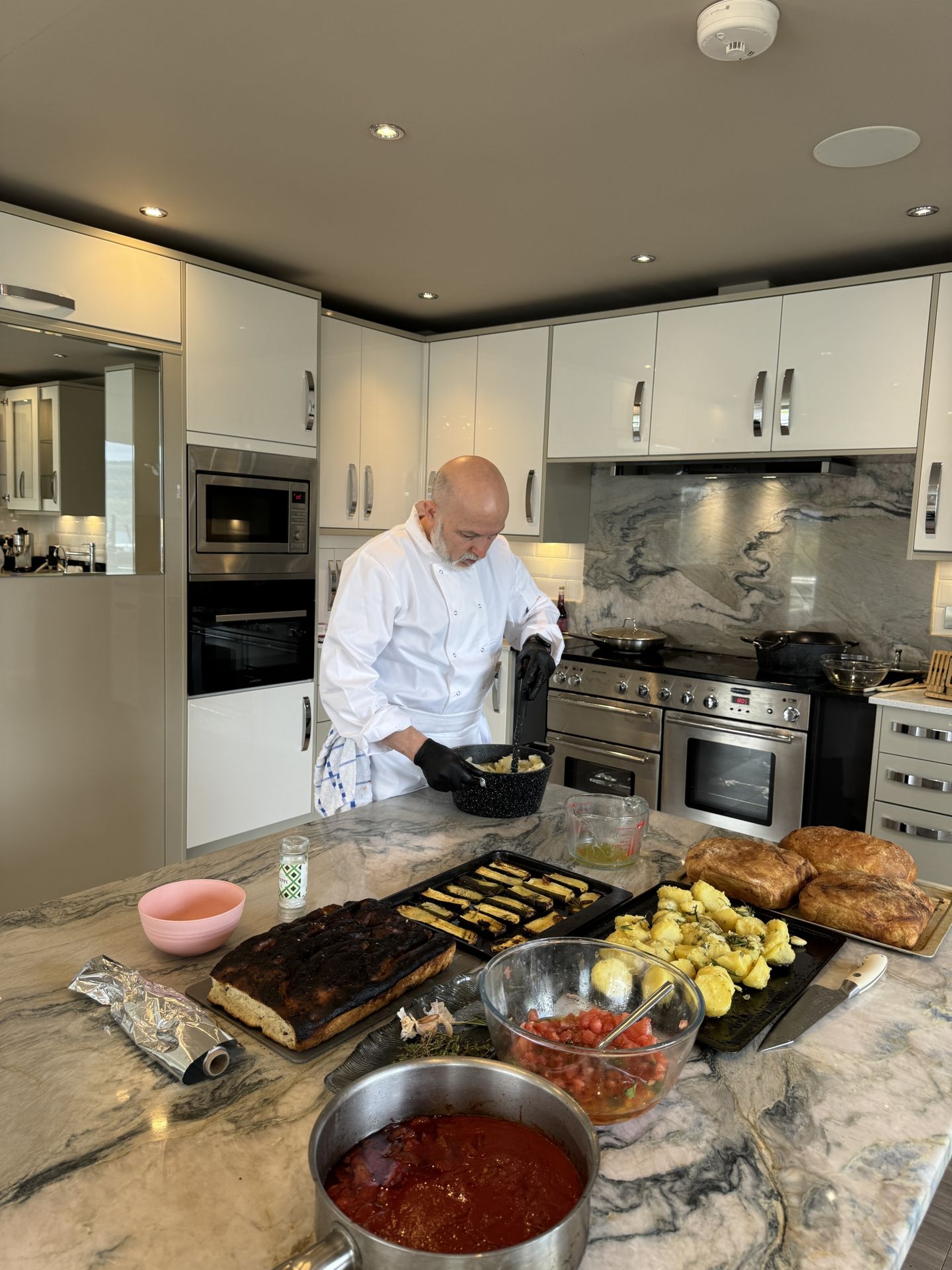 Private chef cooking dinner in a modern Scottish holiday house kitchen.
