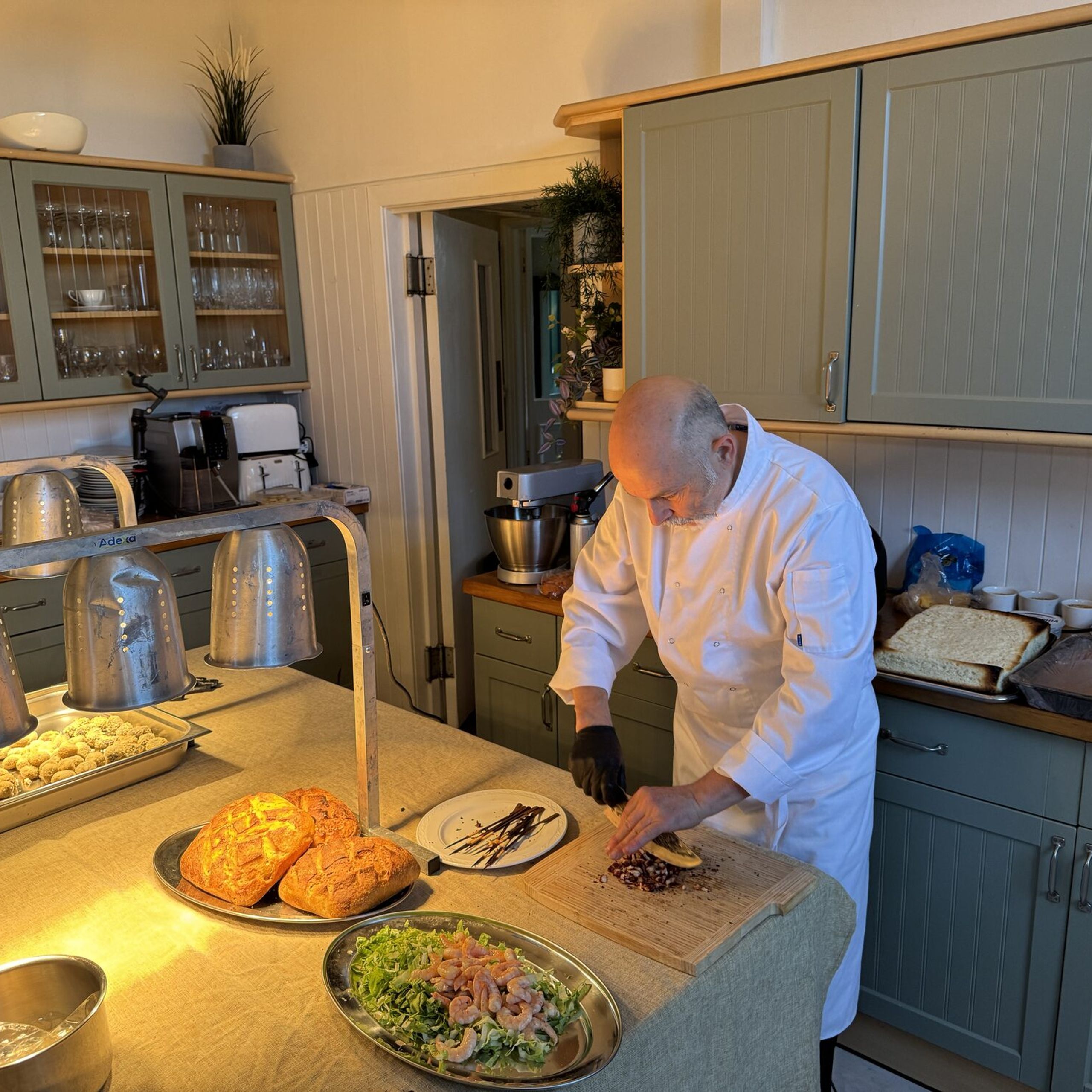 Giuseppe Manzoli preparing canapés and fresh bread in the Beechwood House kitchen
