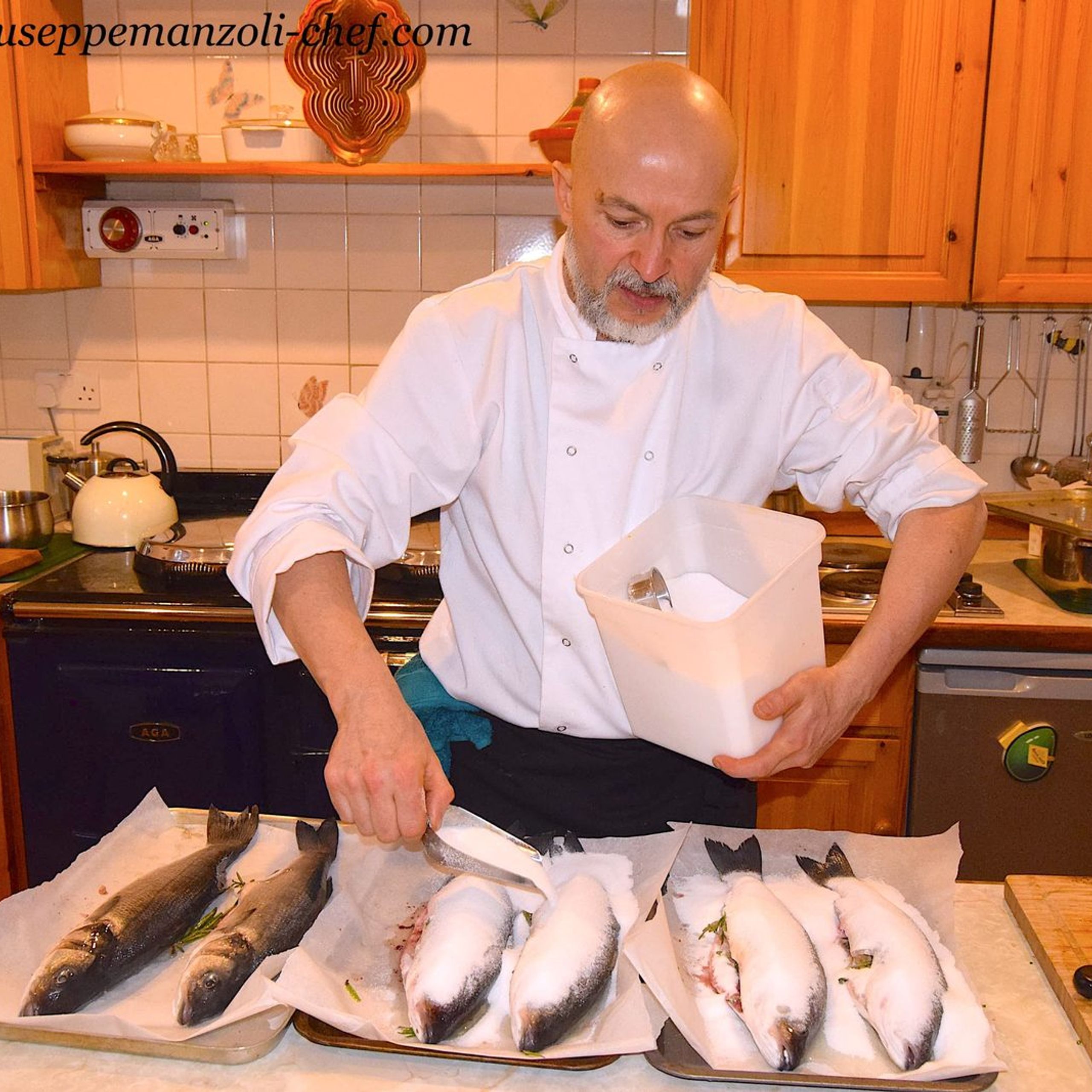 Whole sea bass packed in salt before baking, prepared by private chef Giuseppe Manzoli