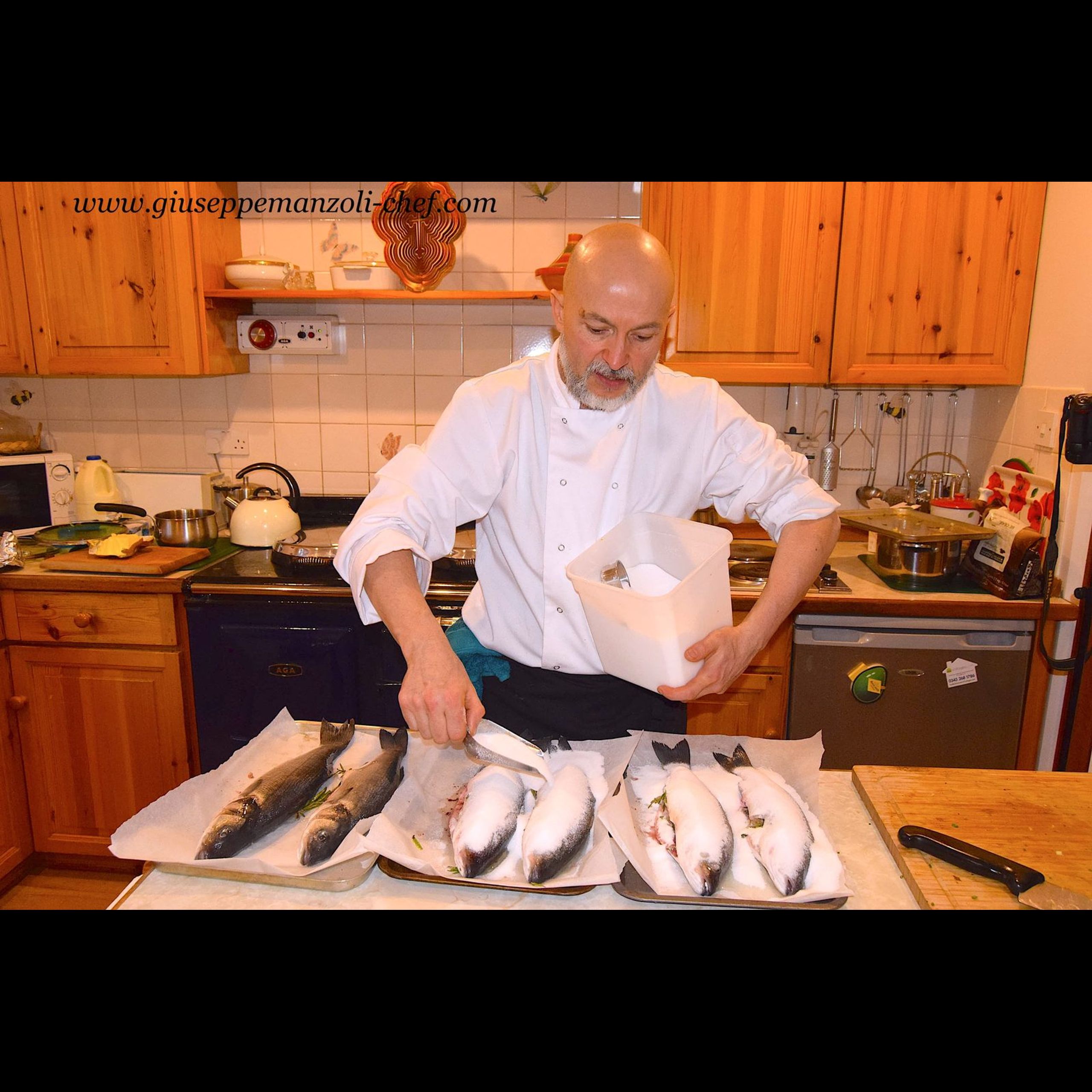 Whole sea bass packed in salt before baking, prepared by private chef Giuseppe Manzoli