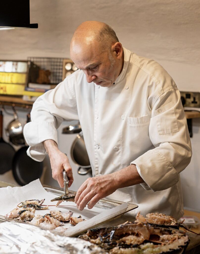 Italian private chef Giuseppe Manzoli preparing langoustines in a private kitchen at Kilmartin Castle, Argyll