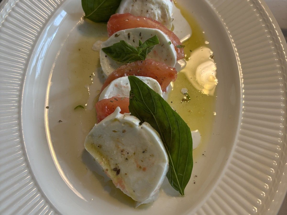 Plated caprese of tomato, mozzarella and basil served by an Italian private chef at Letterewe Lodge, Loch Maree, Wester Ross