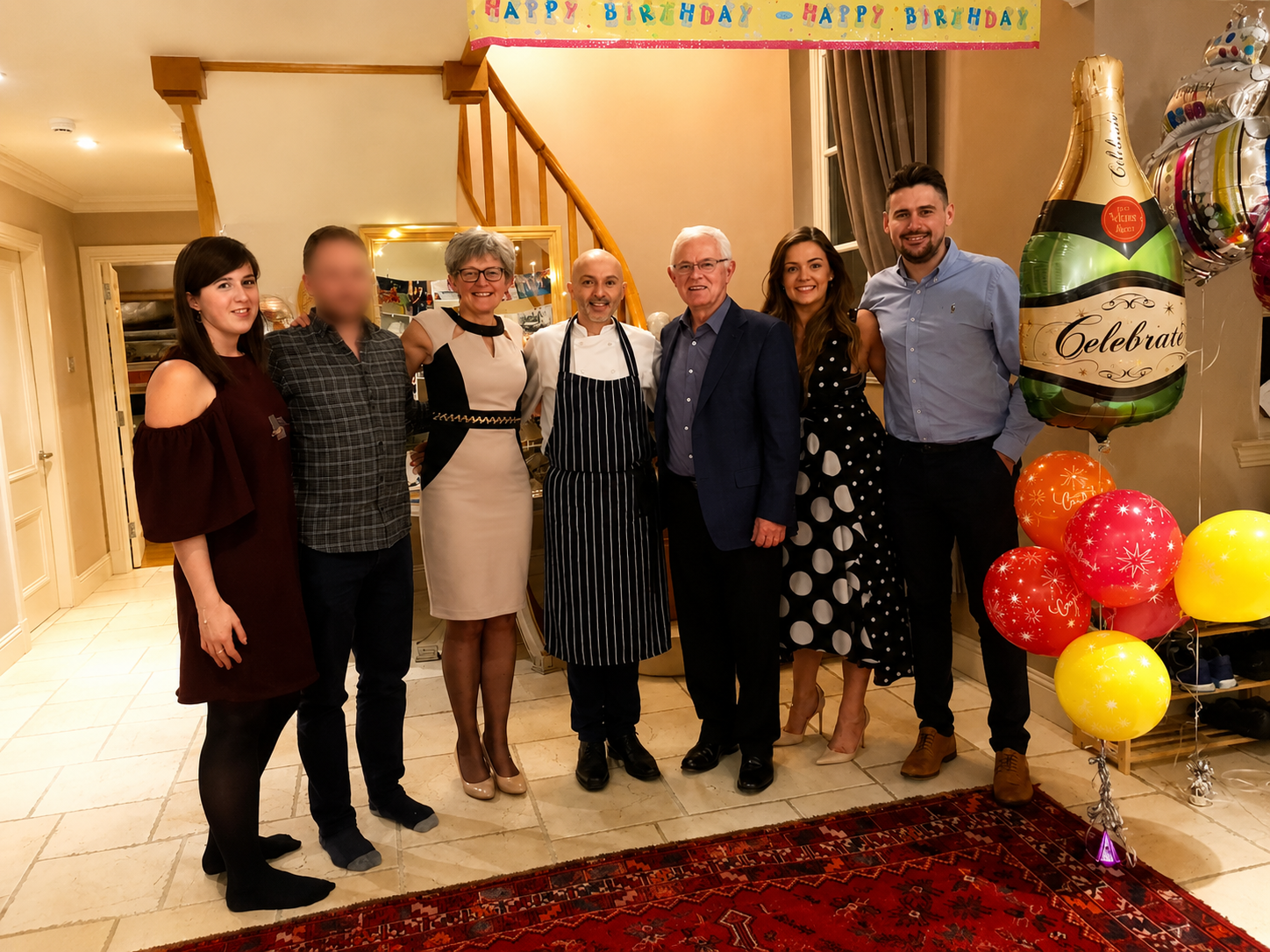 Group of guests standing with a private chef after a birthday dinner in a Scottish holiday house.
